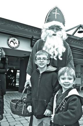 Saint Nicholas with Remi Coleman, 8, and brother Bennett, 4, of Sparta.