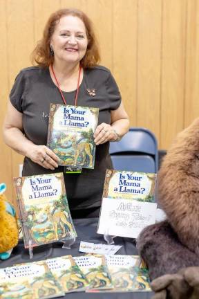 Deborah Guarino sells her children’s classic, ‘Is Your Mama a Llama?,’ at the event.