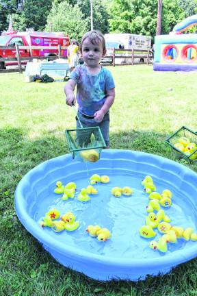 James McCaffrey of Stanhope plays with ducks.