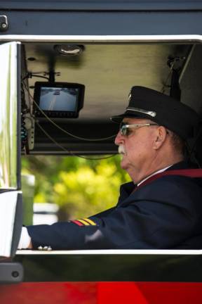 A member of the Byram Township Fire Department drives a firetruck in the parade.