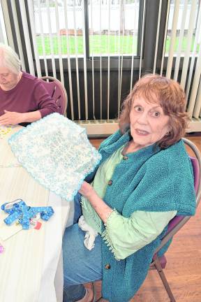 Eileen Ward of Newton holds a craft she's working.