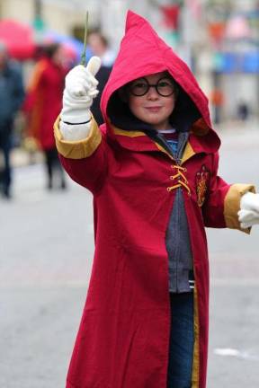 Little wizard raising his wand in the middle of Spring Street.
