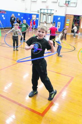 AH3 Students exercise with hula hoops as part of the Kids Heart Challenge fundraiser.