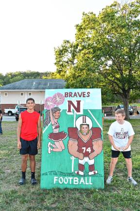 Posing beside and in a cutout at the pep rally are, from left, Jionni Rodriguez of High Point and Reilly McCloske, Nick Ross and Ryan Wikander, all of Newton.