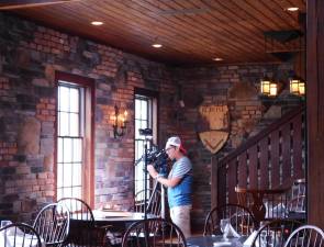 A videographer for Restaurant Hunter balances lighting at the Mohawk House prior to the taping of a segment that will air in September on FIOS 1.