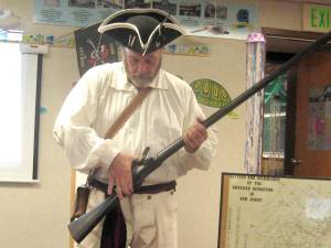 Historian Fred Eckert demonstrates a musket, the preferred distance weapon of New Jersey pirates.