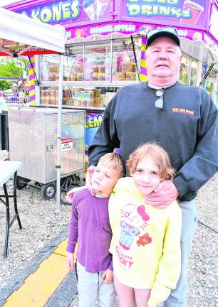 <b>Jim Gaffney of Lafayette stands with his grandchildren, Jack and Theia, in front of a concession stand.</b>