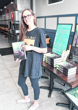 Kelly Catlin of Sparta holds her book.