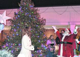Santa Claus celebrates the lighting of the tree.