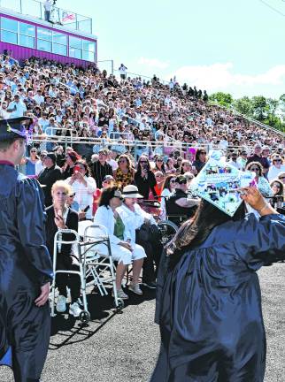 Spectators look on as Lenape Valley Regional High School seniors march in.