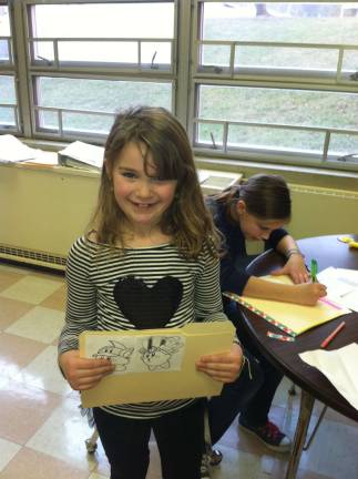 A student at the Stillwater K.E.E.P. program shows off her book.