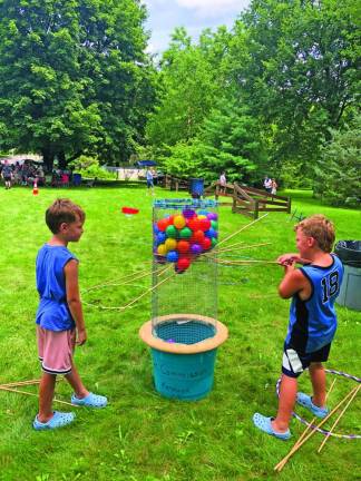 Walter Brummer, 7, and his brother Wade, 6, of Stanhope play a big version of the children’s game KerPlunk.