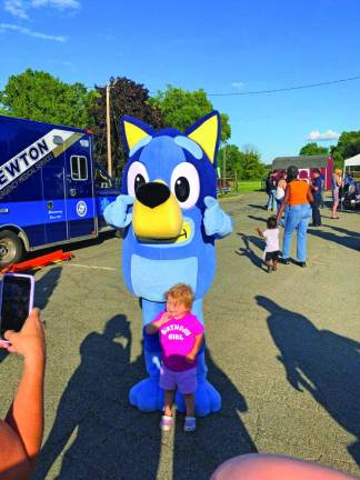 Zoë Smith, 4, of Hewitt celebrates her fourth birthday with the TV cartoon character Bluey.