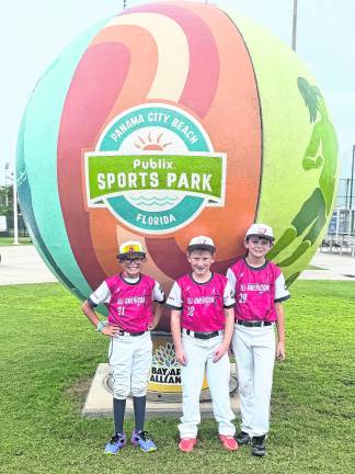 Liam McQueeny, Michael Egger and Jaxon Hiler pose for a photo.