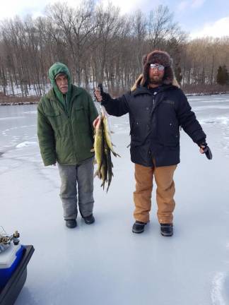 Tadeusz Koscien fishing with his godfather. He enjoys the bonding time out on the ice