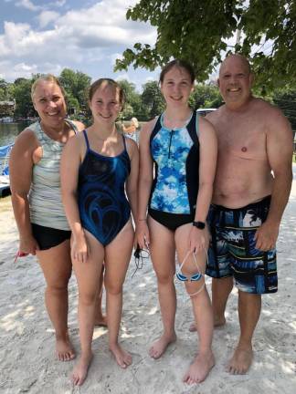 The whole Kaminsky family swam the distance event. Michele, left, coaches her twin daughters, Kelsey and Kayleigh, right, on a summer swim team. Michelle and Shawn were ‘buddies’ for the 14-year-old girls, who finished second and fourth, respectively. (Photo by Kathy Shwiff)
