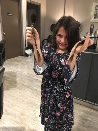 Sadie holds the locks that will be donated