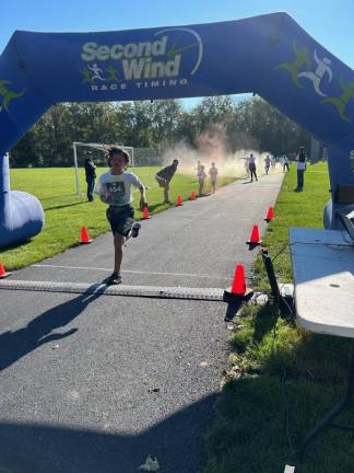 HH3 Aiden Majka is the first to cross the finish line of the 5K with a time of 23 minutes 55 seconds.