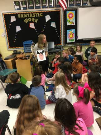 Chelsea Choma, Clinical director at Karen Ann Quinlan Hospice reads to grades K-2 at Ogdensburg Public School from the book, &quot;Germs Are Not For Sharing, by Elizabeth Verdick. (Photo provided)