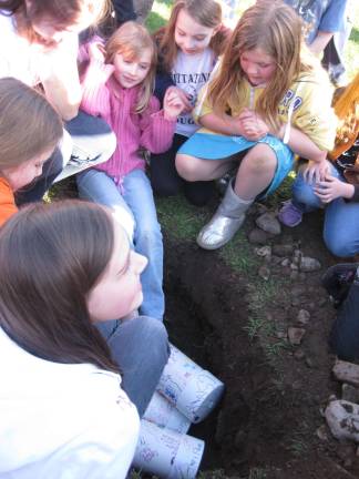 Girls gather to take a last look at the time capsules which will not be unearthed until 2037.