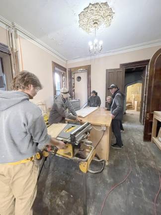 SCCC Students in the Building Construction Technology program are instructed by their professor on the proper use of the equipment.