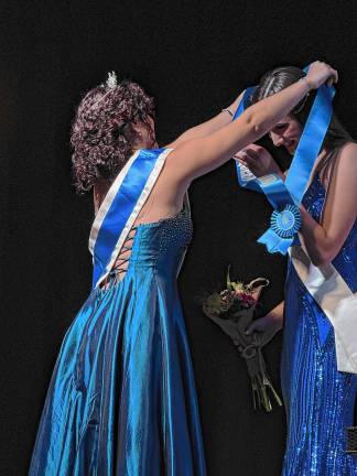 <b>2024 Queen of the Fair </b>Chaya Ortega, left, places the sash on <b>2025 Queen of the Fair </b>Sophie Schaeffner.