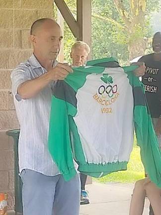 Four time Olympian Marcus O’Sullivan shows 2021 campers a jacket from the Olympics.