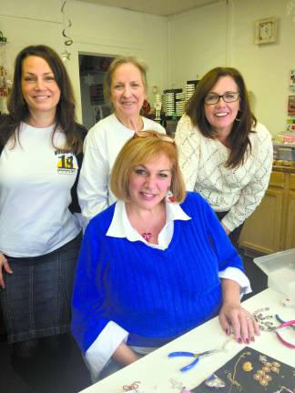 Photo by Laurie Gordon (From left to right) Stacey Cudnik (11th Hour Rescue), Delores Alimi (11th Hour Rescue), Susie Fenimore (Designs by Susie-Q), and Sandra Pregno (Lenepe Valley Job Coach) gather to watch students learn how to make jewelry they will sell.