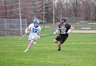 Kittatinny's Carter Festa carries the ball while being shadowed by West Milford's Spencer Ribitzki. Festa is credited with scooping up three ground balls in the April 4 game won by the Highlanders, 7-3. (Photos by George Leroy Hunter)