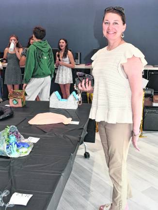 Jessica Brennan of Stanhope stands in front of a table.
