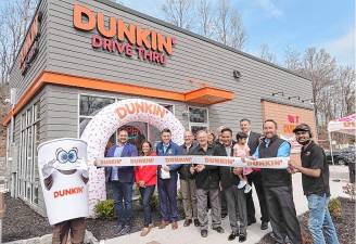 DK1 A ceremonial ribbon-cutting Thursday, April 10 marks the grand opening of Andover Dunkin’ at 165 Main St. From left are the mascot Cuppy, Dunkin’ business consultant Ben Bogiages, Dunkin’ franchise operations director Stacey Goetz, Assemblyman Michael Inganamort, Dunkin’ architect Frank Truilo, Andover Borough Mayor John Morgan, Cindy Smith, Andover Councilman Bob Smith, Dunkin’ franchisee Ashwin Prajapati, Inganamort’s chief of staff Brett Conrads, Andover Borough Volunteer Fire Chief Jessica Casella, Dunkin’ franchisee AP QSR MGMT’s district manager Sean McCarthy and Andover Borough Dunkin’ manager Vick Prajapati. (Photo provided)