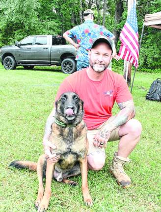 James Baker of Baker Acres K9 Foundation of mt. olive posing with his dog Ned, a therapy dog for people with PTSD.
