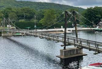 The Cranberry Lake footbridge was ordered closed by the state in 2019. A local nonprofit organization is working to have the bridge, which was built in 1930, repaired and reopened. (Photos provided)