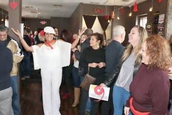 Frances Bachmann demonstrates her enthusiasm as guests enjoy the festive event, while also contributing to a worthy cause.