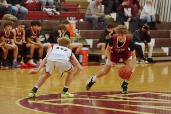 Newton's Cooper Armstrong maneuvers the ball while covered by West Milford's John DelVecchio in the first half Saturday, Jan. 20. The Braves lost, 53-52. (Photos by George Leroy Hunter)