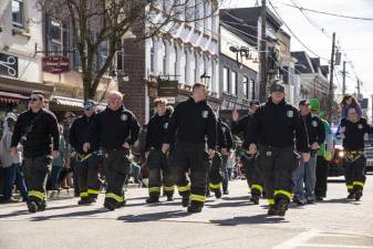 Members of the Newton Fire Department march in the St. Patrick’s Day Parade on March 18 in Newton. (Photos by John Hester)