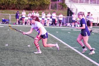 LV1 Lenape Valley's Regina Williams scoops up a ground ball with her crosse in the game against Pope John on May 1. She scored four goals and the Patriots won, 8-7. (Photos by George Leroy Hunter)