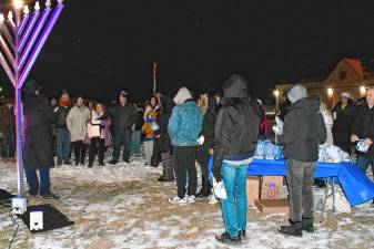 <b>Residents gather for a menorah lighting Thursday, Dec. 26 in Vernon. Candles traditionally are lit in menorahs for each of the eight nights of Hanukkah. The Jewish holiday began Dec. 25 and ends Jan. 1. (Photo by Maria Kovic)</b>