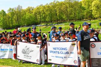 Teams line up behind their sponsors’ banners on the Lenape Valley Little League’s opening day Saturday, May 3 at C.O. Johnson Park in Byram. (Photos by Maria Kovic)