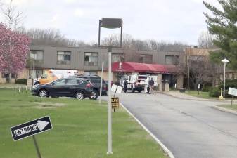 Ambulance crews are parked outside Andover Subacute and Rehabilitation Center in Andover, N.J., on Thursday April 16, 2020. (AP Photo/Ted Shaffrey)