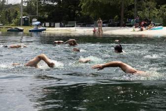 Participants begin a 580-meter swim leaving from and returning to the Lindy’s Lake beach Sunday, Aug. 6. (Photo by John Caggiano)