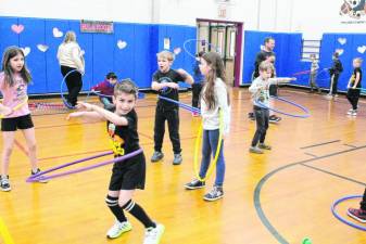 AH1 Students exercise with hula hoops as part of the Kids Heart Challenge fundraiser.