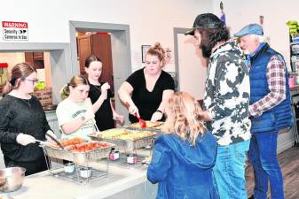 CE1 Members of the Culinary Explorers, a 4-H cooking club, serve a pasta dinner to raise funds Saturday, Feb. 24 at the Stillwater Community Center in Newton. (Photos by Maria Kovic)