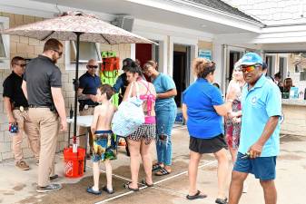 Residents line up for ice cream sandwiches during the Ice Cream with a Cop event Tuesday, July 15 at the Newton town pool. (Photos by Maria Kovic)