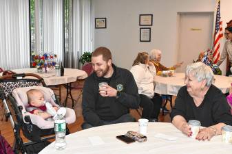 NCC1 Newton Police Detective Peter Vex and Marilyn Miller have coffee with a very young resident at a Coffee with a Cop event at Liberty Towers on Thursday, May 22. (Photos by Maria Kovic)