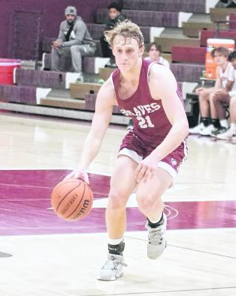 Newton's Nick Kurilko dribbles the ball. Kurilko scored 13 points.