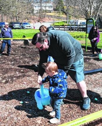 A father helps his son hunt for Easter eggs Sunday, March 24 in Musconetcong Park in Stanhope.