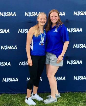 Kaylee (L) with her coach (R). Kaylee broke the school record in triple jump, and finished 5th in the meet of champions this week. (Photo provided)