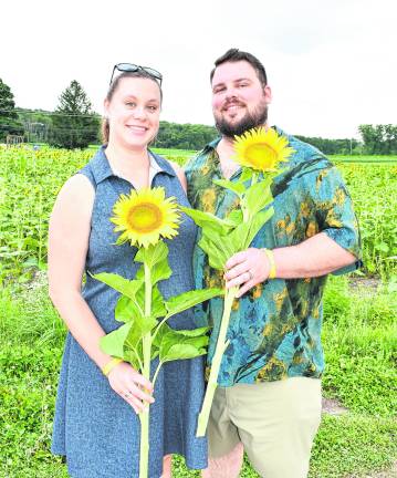 Andy and Jessica Osolin of Hamburg pose with sunflowers.