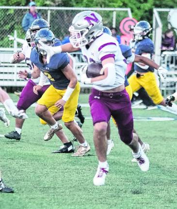 Newton ball carrier Braxton Guerra runs in the first half.